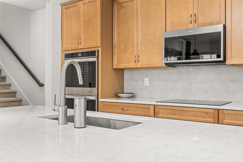 1849 Island Village Way Celebration, FL 34747 - Photo 15 of 50 a view of a kitchen with microwave and cabinets