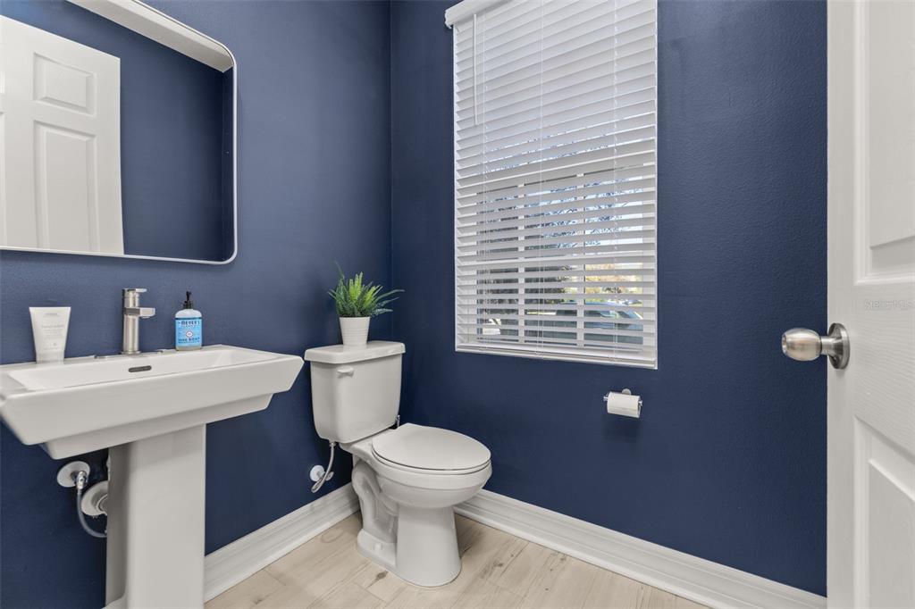 1849 Island Village Way Celebration, FL 34747 - Photo 18 of 50 a bathroom with a toilet a sink and a window