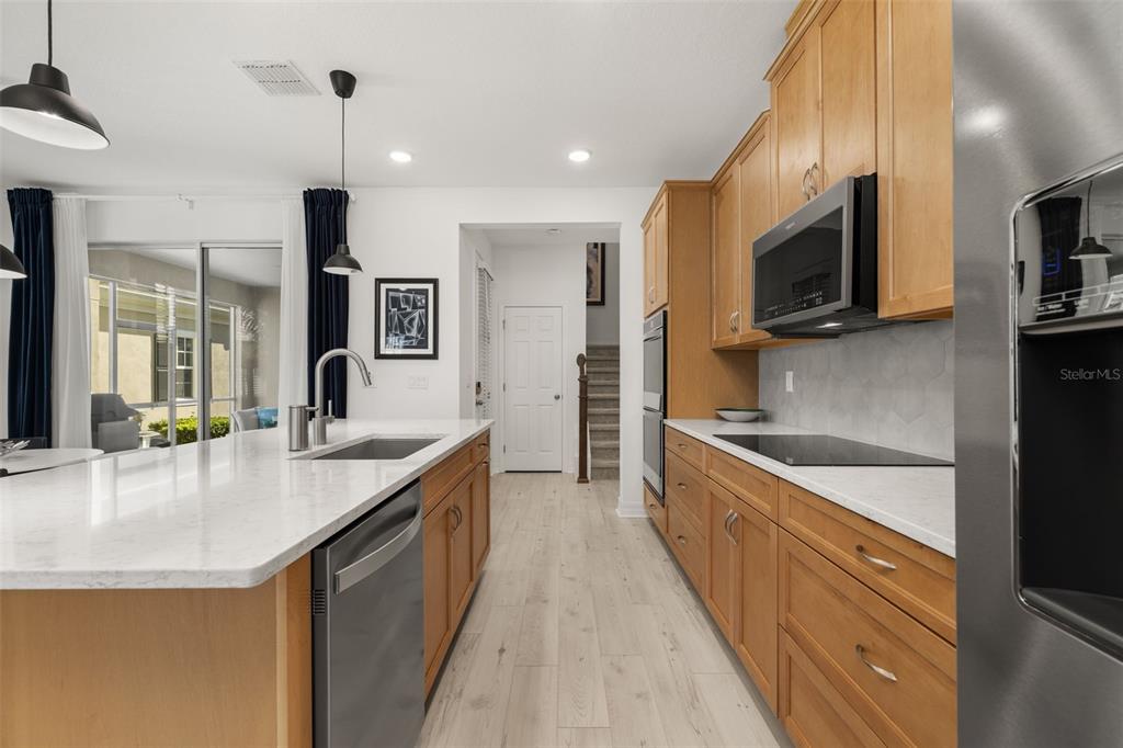 1849 Island Village Way Celebration, FL 34747 - Photo 21 of 50 a large kitchen with stainless steel appliances a sink and a stove