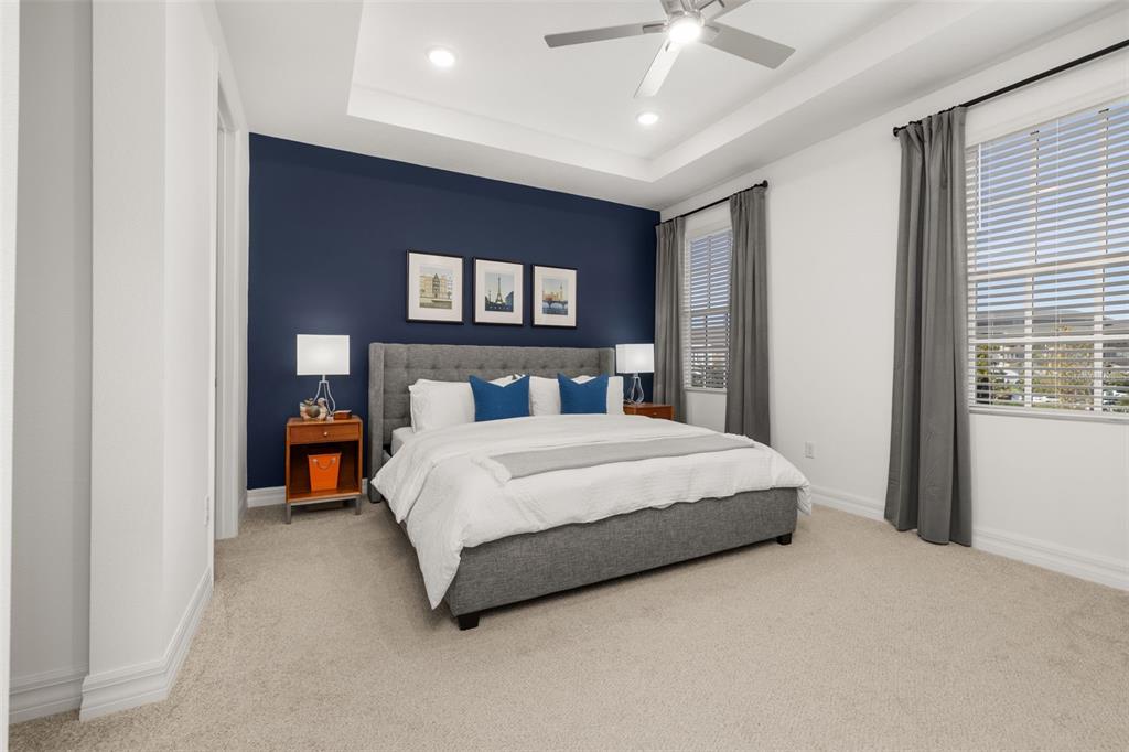 1849 Island Village Way Celebration, FL 34747 - Photo 25 of 50 a bedroom with a bed and a ceiling fan