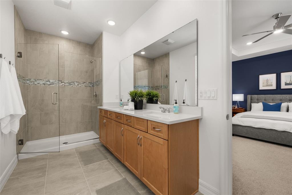 1849 Island Village Way Celebration, FL 34747 - Photo 28 of 50 a bathroom with double vanity sink and shower