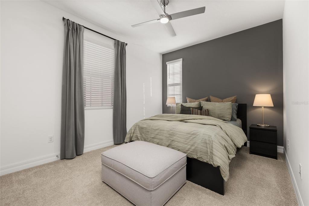 1849 Island Village Way Celebration, FL 34747 - Photo 33 of 50 a bedroom with a bed and a chandelier