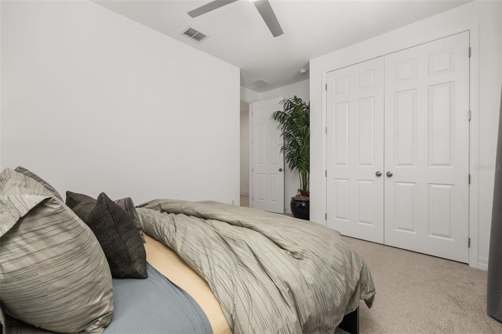 1849 Island Village Way Celebration, FL 34747 - Photo 34 of 50 a bedroom with a bed and a potted plant