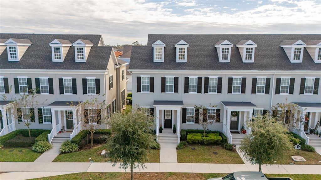 1849 Island Village Way Celebration, FL 34747 - Photo 47 of 50 a front view of a residential apartment building with a yard