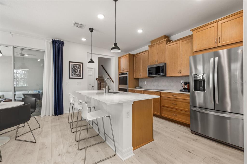 1849 Island Village Way Celebration, FL 34747 - Photo 5 of 50 a kitchen with kitchen island a counter top space appliances and a cabinets