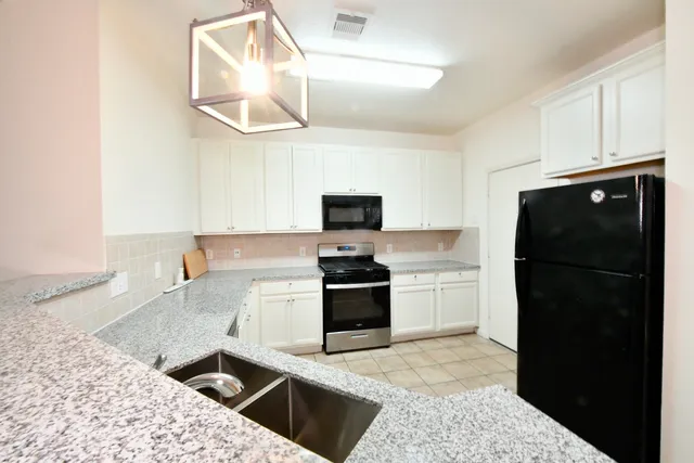 a kitchen with a stove and a refrigerator