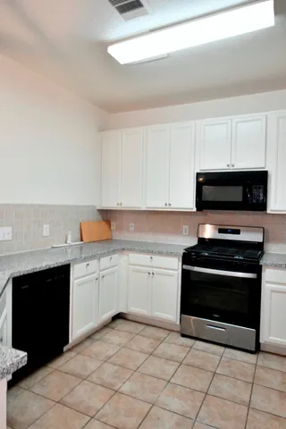 a kitchen with a stove and a microwave