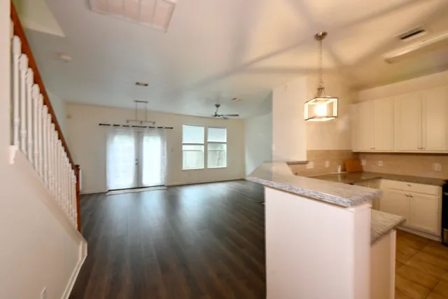 a view of a kitchen with a sink dishwasher a refrigerator and wooden floor