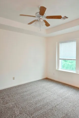 a bathroom with a granite countertop toilet and a sink