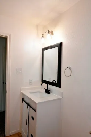 a bathroom with a sink a toilet and a shower