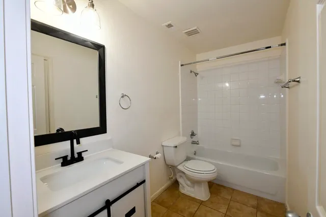 an empty room with a ceiling fan and window