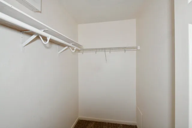 a bathroom with a granite countertop sink a toilet and a mirror
