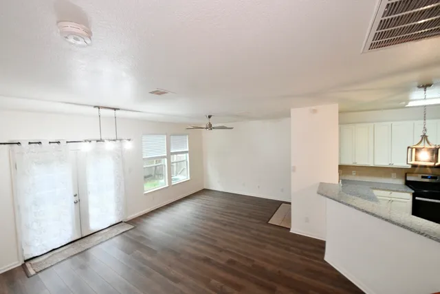 a view of a kitchen with wooden floor