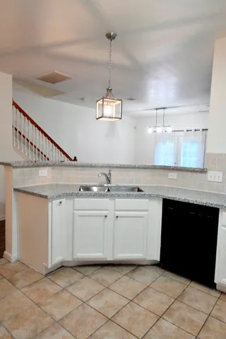 a kitchen with a sink and cabinets