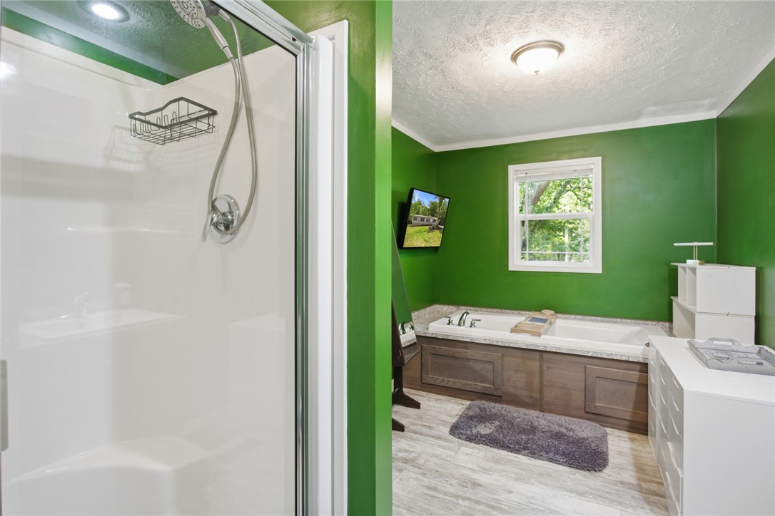 119 Fruit Mountain Road Easley, SC 29640 - Photo 4 of 31 This bathroom features a contemporary shower and a relaxing tub, creating a refreshing personal sanctuary.