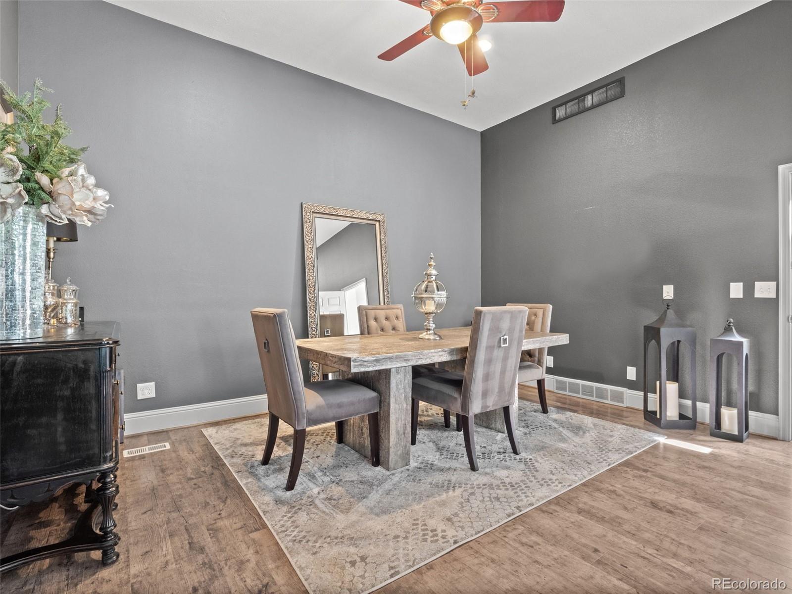 6595 West 46th Place Wheat Ridge, CO 80033 - Photo 14 of 48 a view of a dining room with furniture and wooden floor