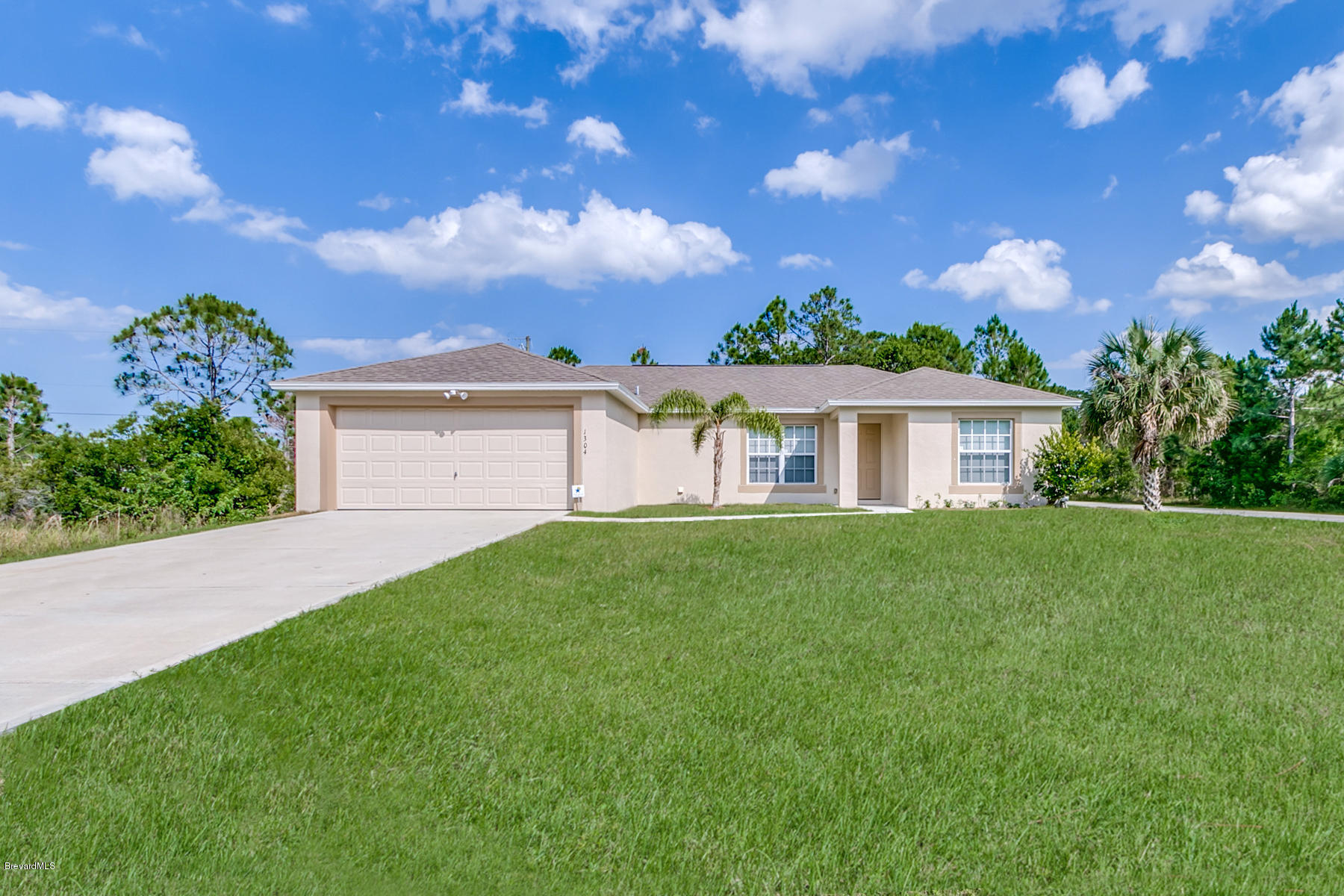 1304 Rabbit Street Southeast Palm Bay, FL 32909 - Photo 1 of 37 a view of a house with a yard
