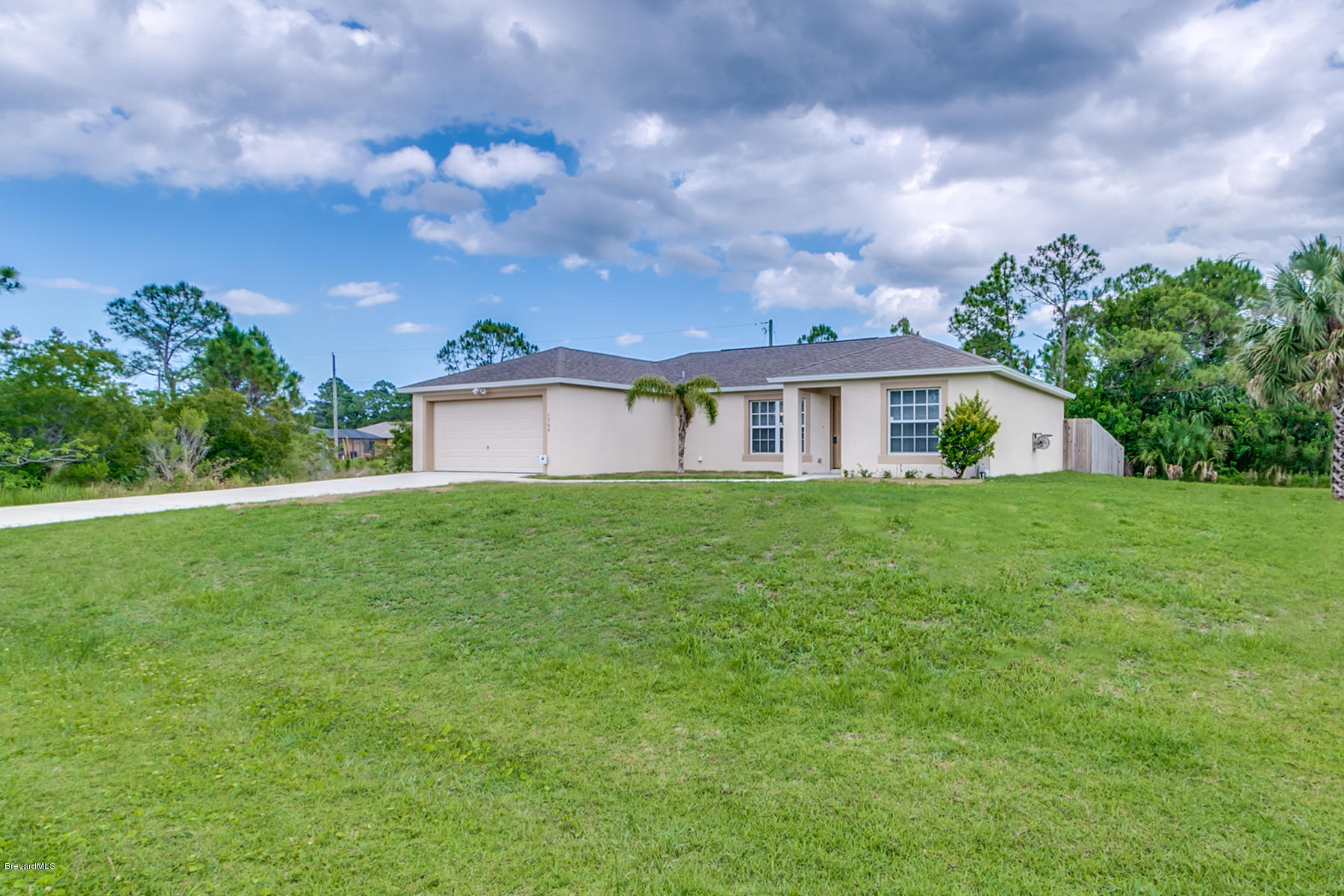 1304 Rabbit Street Southeast Palm Bay, FL 32909 - Photo 6 of 37 a view of house that has a big yard