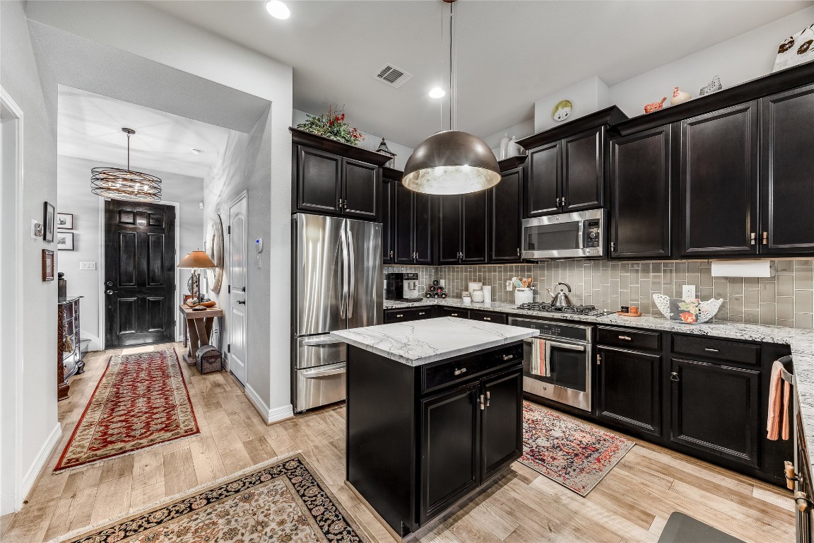 2930 Grand Oaks Loop, Unit 2901 Cedar Park, TX 78613 - Photo 13 of 33 a kitchen with stainless steel appliances granite countertop a stove refrigerator a sink and dishwasher