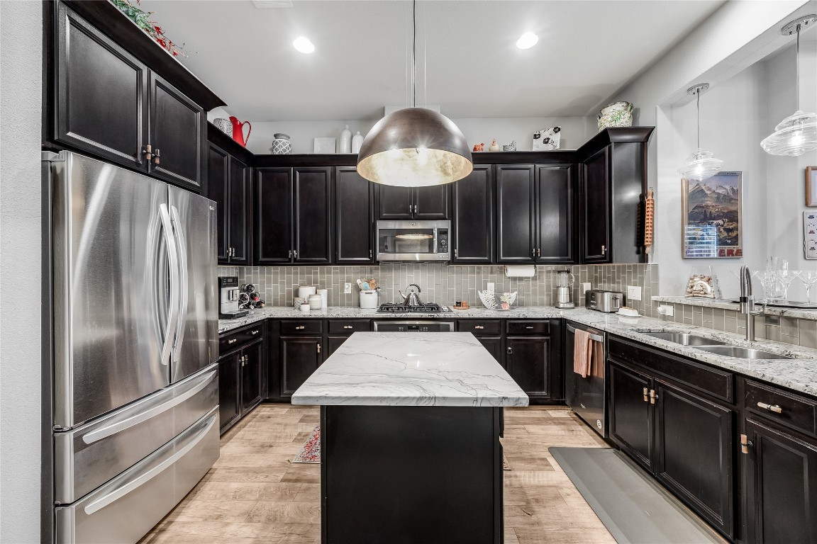 2930 Grand Oaks Loop, Unit 2901 Cedar Park, TX 78613 - Photo 14 of 33 a kitchen with a sink stainless steel appliances and cabinets