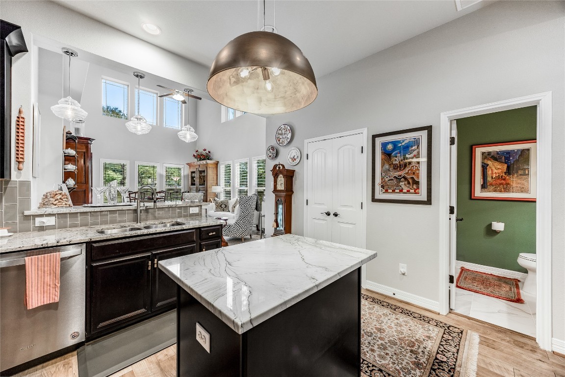 2930 Grand Oaks Loop, Unit 2901 Cedar Park, TX 78613 - Photo 15 of 33 a kitchen with stainless steel appliances granite countertop a sink dishwasher and a stove with wooden floor