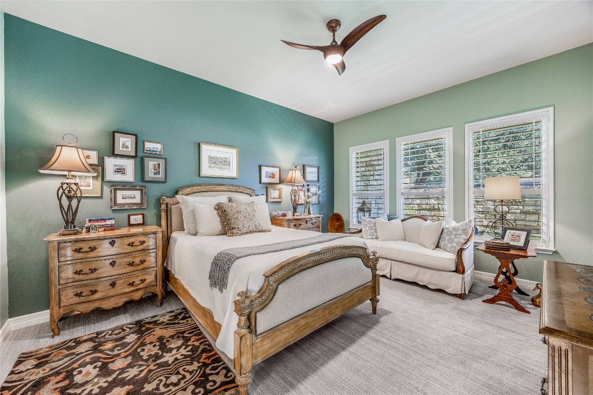 2930 Grand Oaks Loop, Unit 2901 Cedar Park, TX 78613 - Photo 17 of 33 a bedroom with a bed a couch and large windows