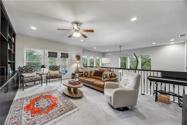 a living room with furniture a rug and a large window
