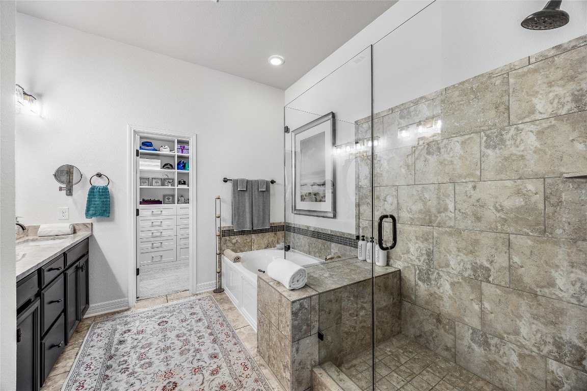 2930 Grand Oaks Loop, Unit 2901 Cedar Park, TX 78613 - Photo 21 of 33 a bathroom with a sink a vanity and shower