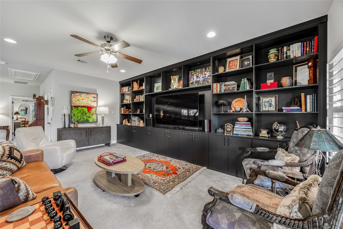 2930 Grand Oaks Loop, Unit 2901 Cedar Park, TX 78613 - Photo 23 of 33 a living room with furniture and a book shelf