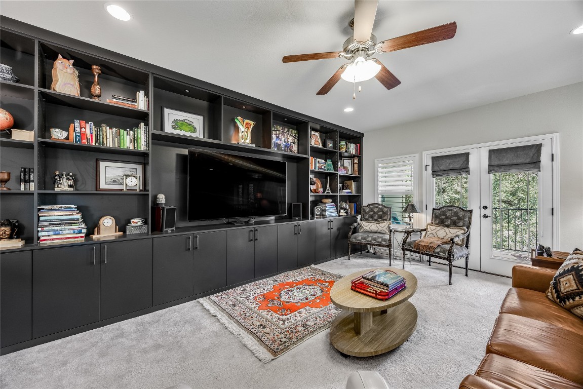 2930 Grand Oaks Loop, Unit 2901 Cedar Park, TX 78613 - Photo 24 of 33 a living room with furniture a flat screen tv and a book shelf