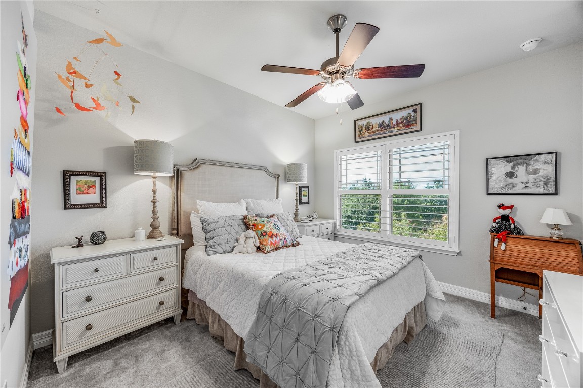 2930 Grand Oaks Loop, Unit 2901 Cedar Park, TX 78613 - Photo 30 of 33 a bedroom with a bed and a chandelier