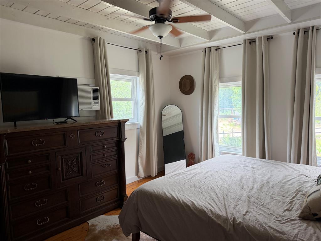 111 Apache Trail Whitney, TX 76692 - Photo 12 of 40 a bedroom with a bed and a flat screen tv