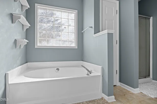 a view of an empty room with a fireplace and a window