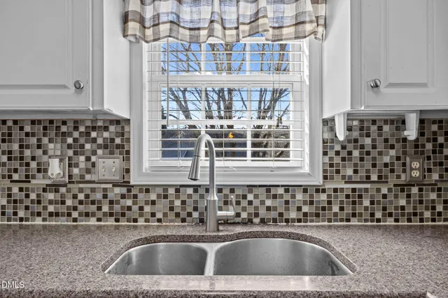 a view of a house with backyard and garden