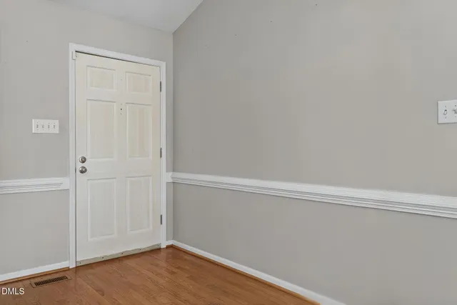 a view of a workspace with furniture and wooden floor