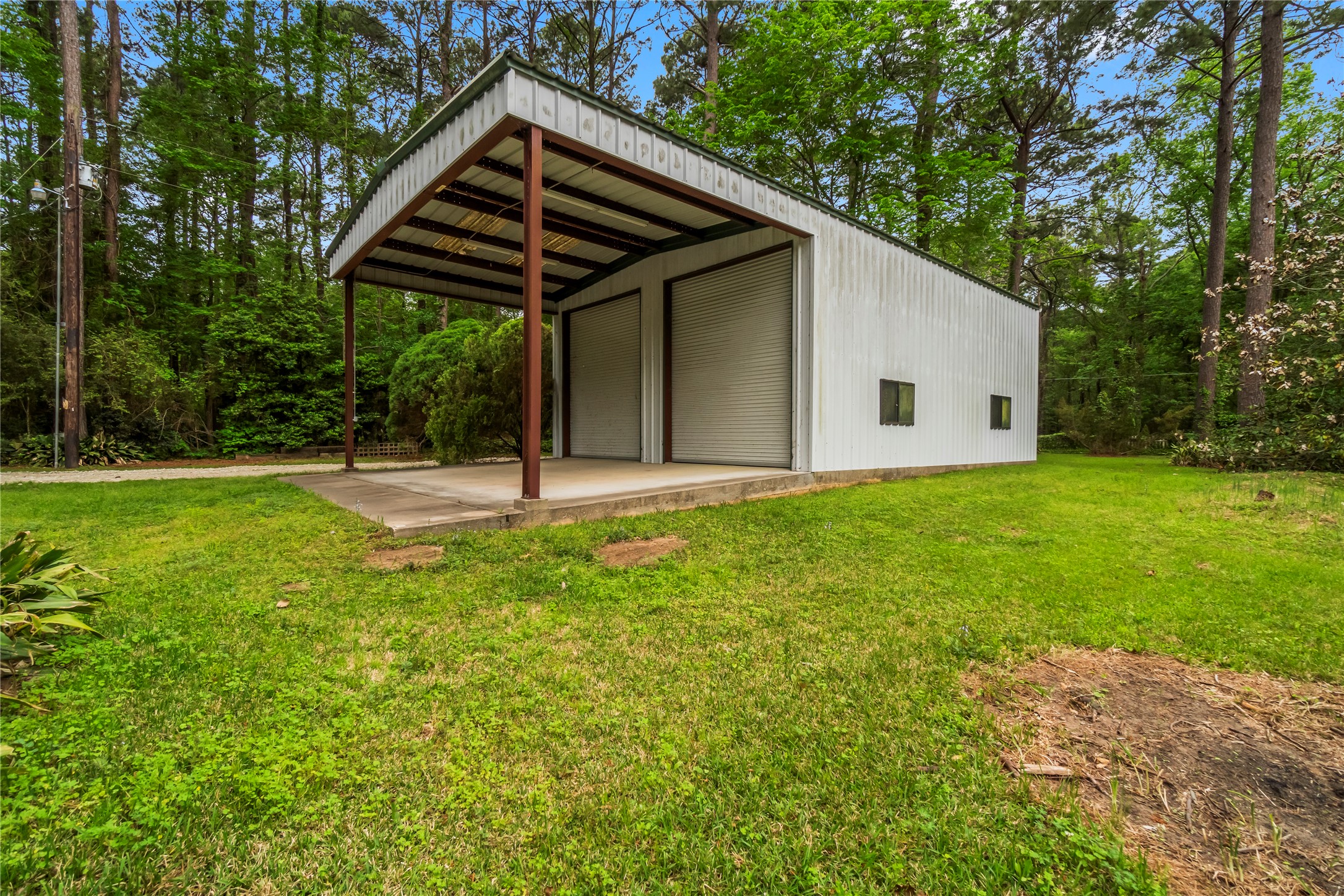 200 Johnson Road Coldspring, TX 77331 - Photo 11 of 49 a backyard of a house with table and chairs