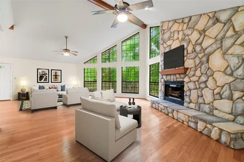 a view of an empty room with a fireplace and a window