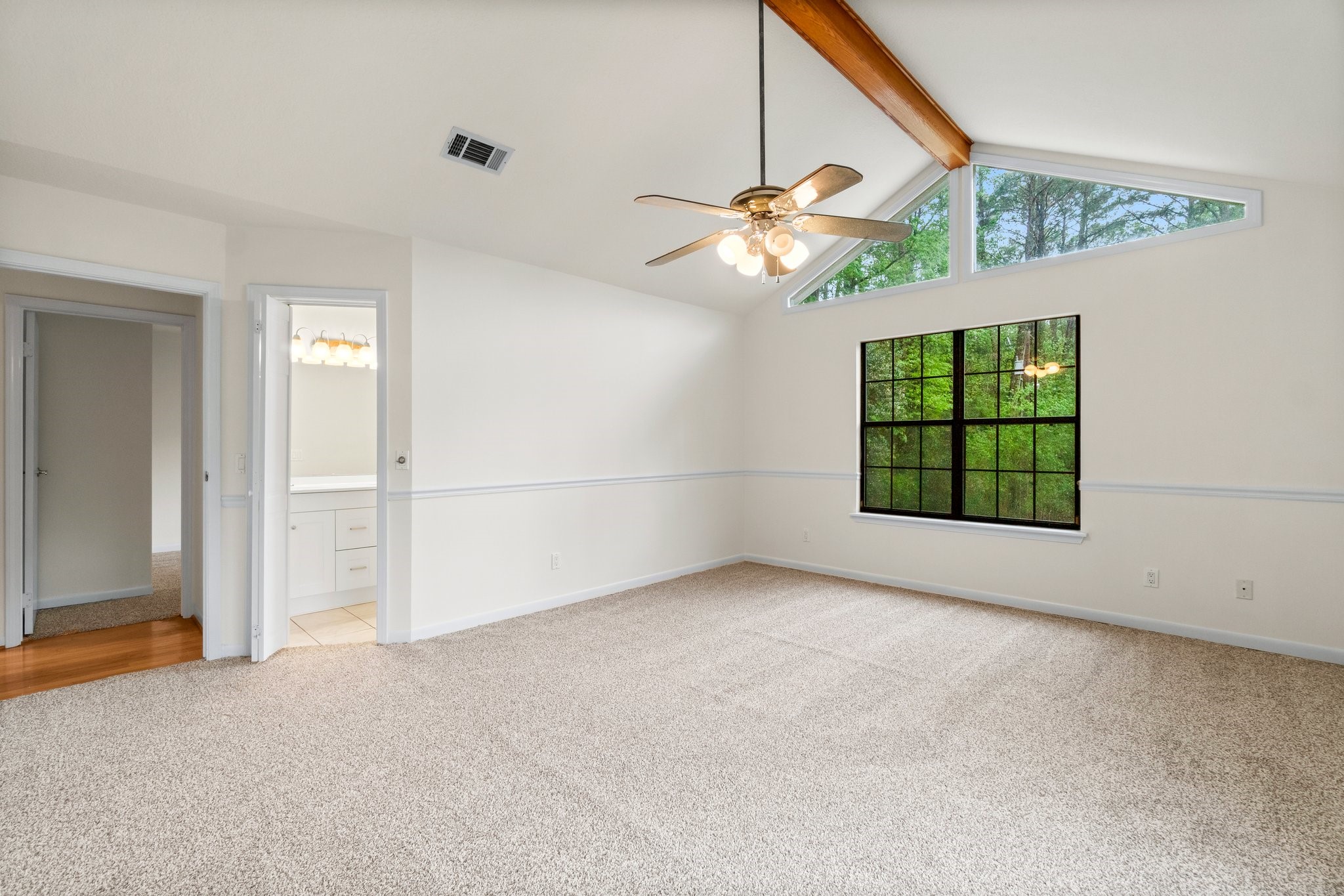 200 Johnson Road Coldspring, TX 77331 - Photo 31 of 49 an empty room with windows and ceiling fan