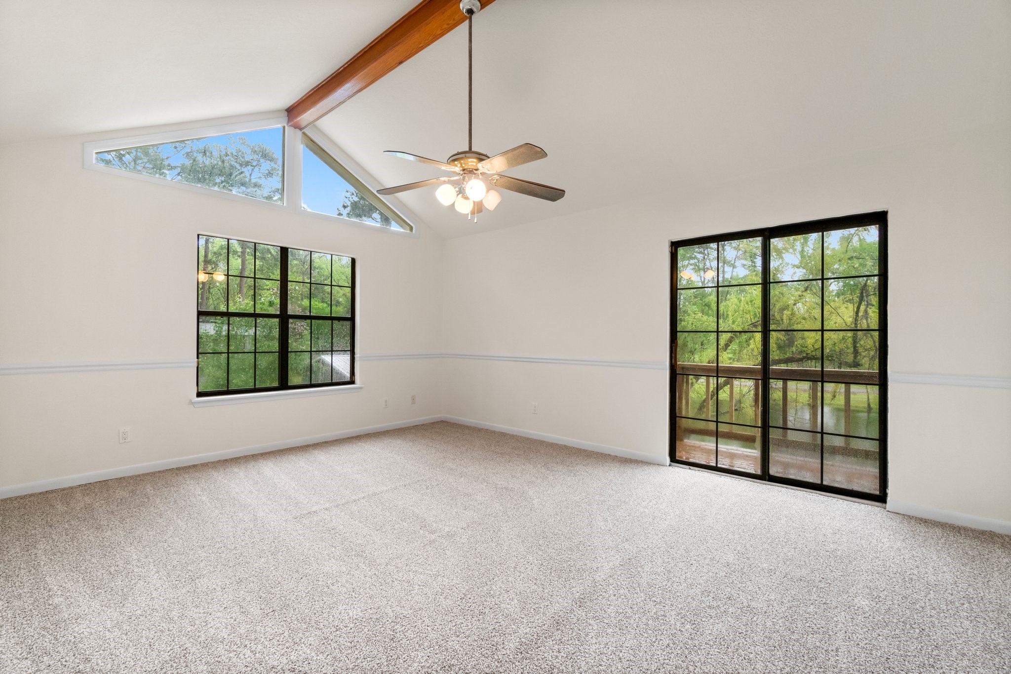 200 Johnson Road Coldspring, TX 77331 - Photo 32 of 49 an empty room with windows and ceiling fan