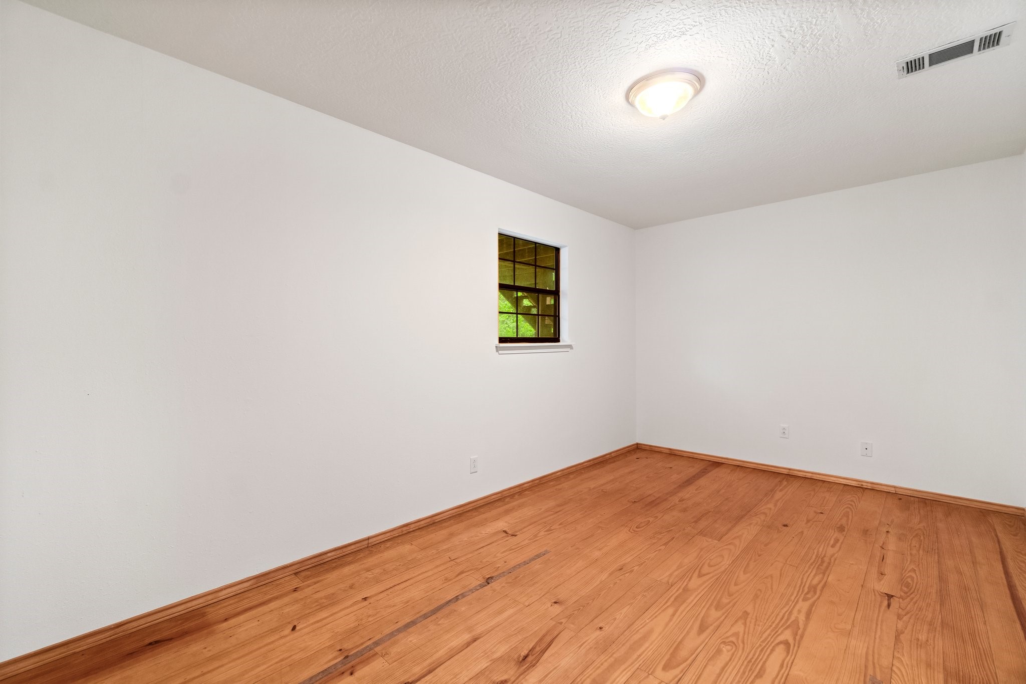 200 Johnson Road Coldspring, TX 77331 - Photo 42 of 49 a view of empty room with wooden floor and fan