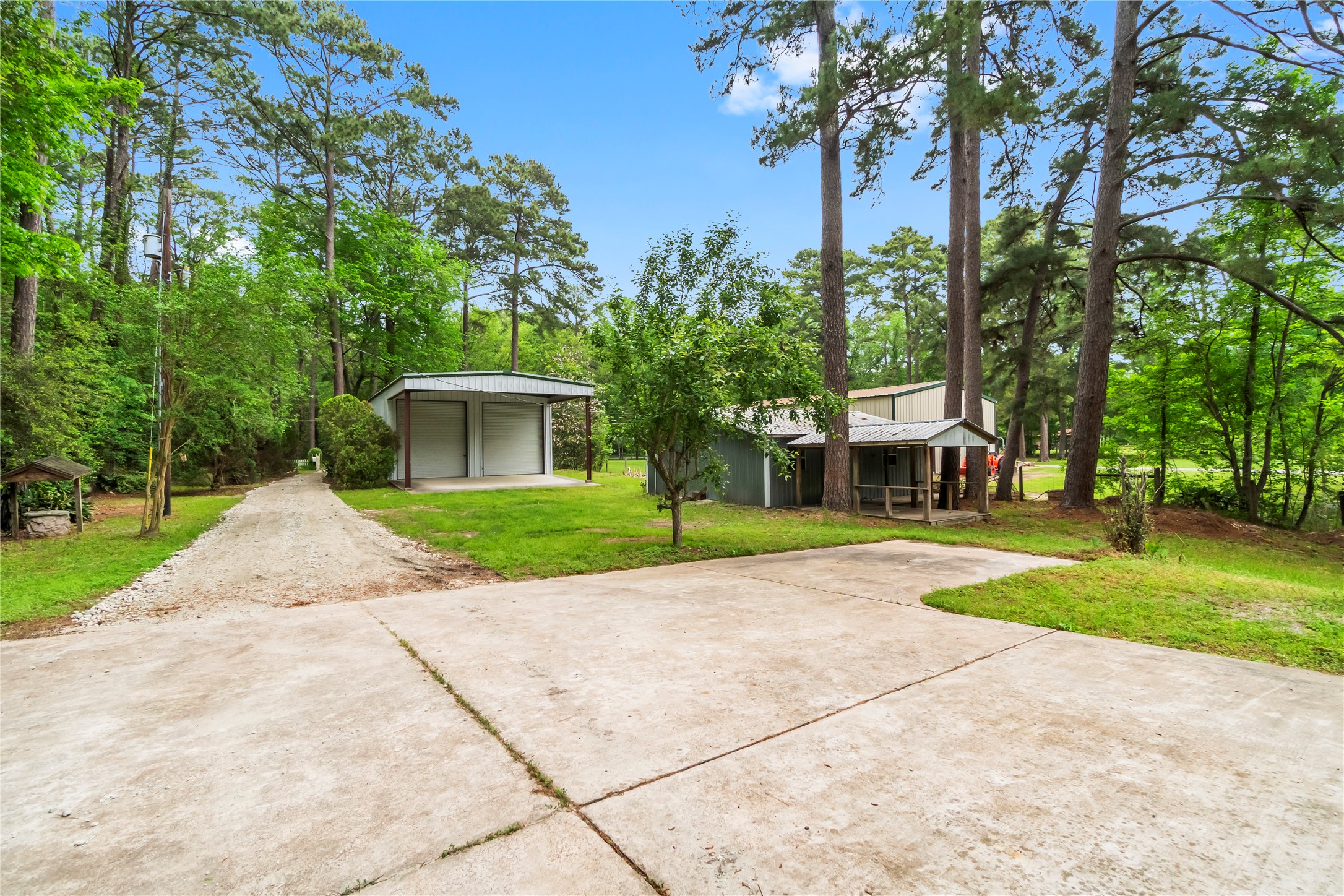 200 Johnson Road Coldspring, TX 77331 - Photo 47 of 49 a view of a house with a yard and large trees