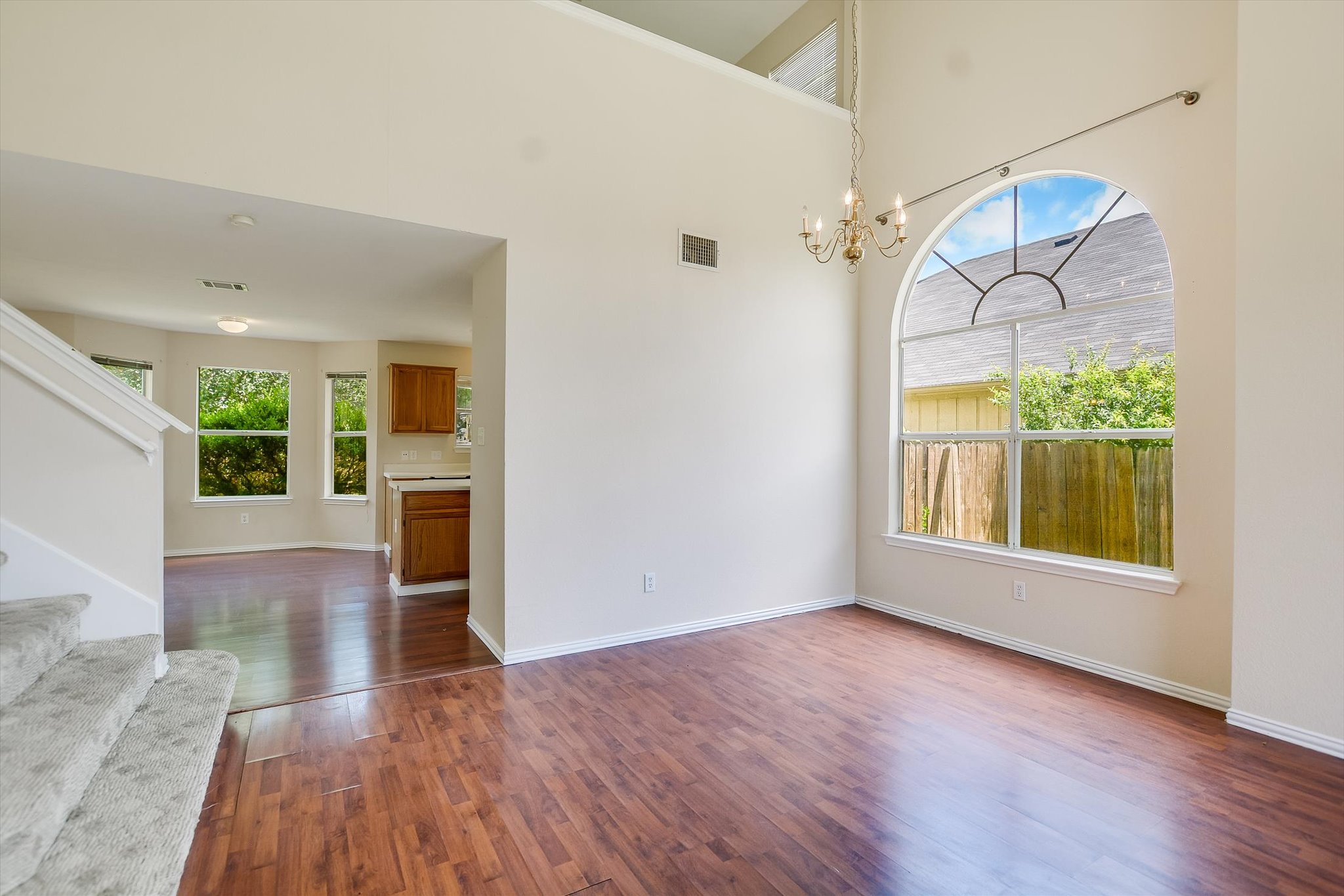 1008 Double File Trail Round Rock, TX 78665 - Photo 5 of 20 A spacious dining area with hardwood floors and a striking arched window.