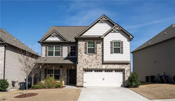 a front view of a house with a yard