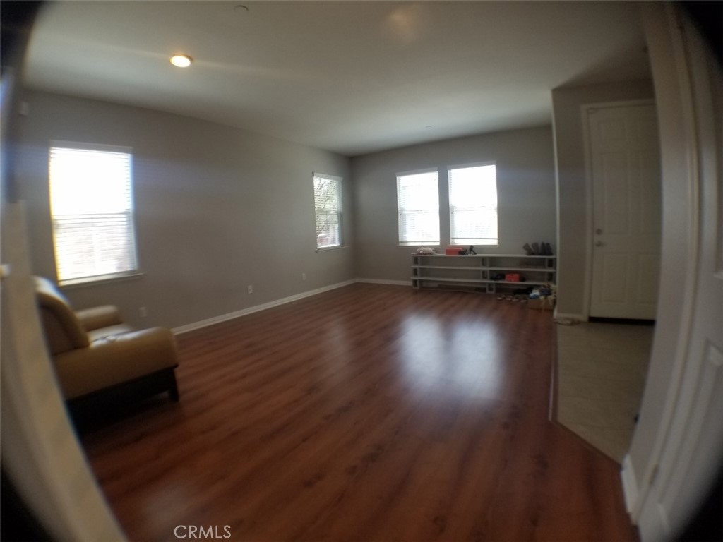 1688 Julia Way Riverside, CA 92501 - Photo 16 of 36 an empty room with wooden floor and windows