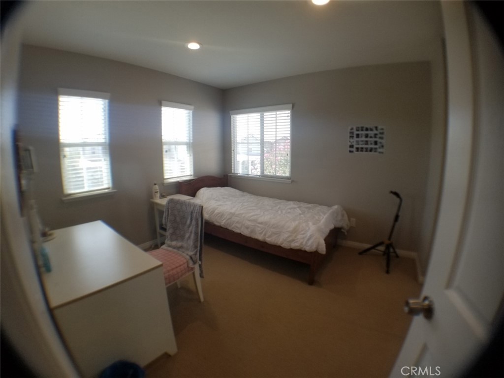 1688 Julia Way Riverside, CA 92501 - Photo 8 of 36 a bedroom with a bed and a chair in it