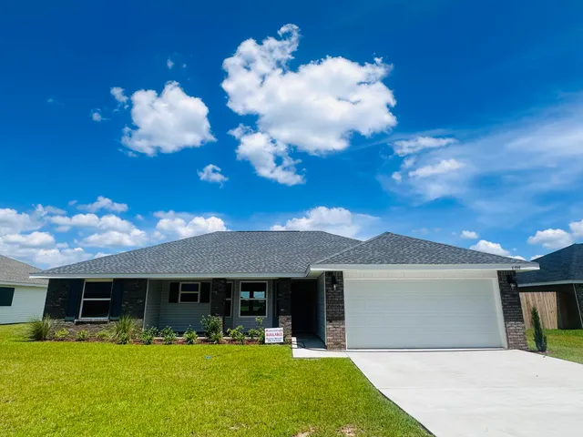 a front view of house with yard and seating area