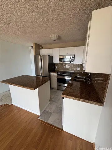 a kitchen with a sink a stove and refrigerator