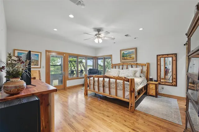 a spacious bedroom with a bed and a table in it