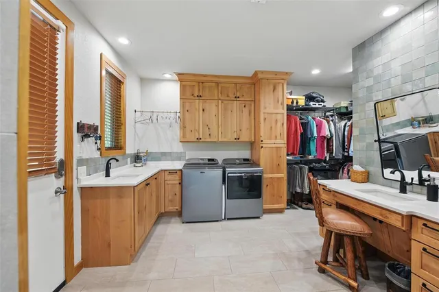 a large kitchen with stainless steel appliances a sink stove and cabinets