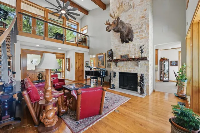 a living room with furniture a fireplace and potted plants